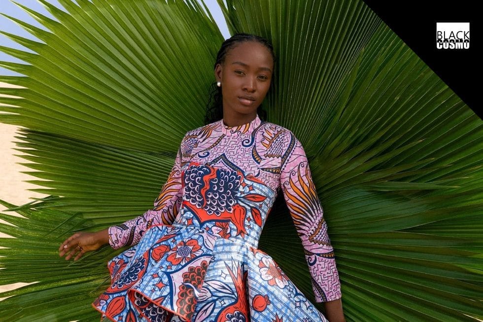 Togo Yeye is putting Togo’s creative scene on the map with its new Vlisco collaboration. A model in a wax print dress stands behind a large, green plant.