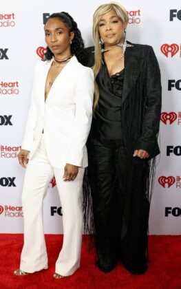 Kehlani stuns in a red satin corset and voluminous Cinderella-style skirt at the 2026 iHeartRadio Music Awards red carpet.