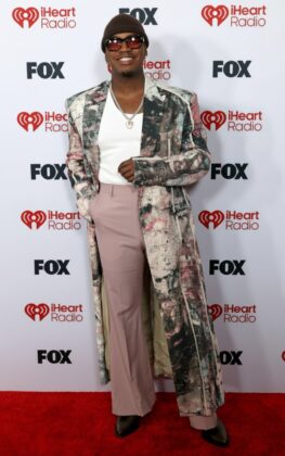 Kehlani stuns in a red satin corset and voluminous Cinderella-style skirt at the 2026 iHeartRadio Music Awards red carpet.