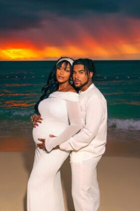 A radiant Nzinga Imani glowing and embracing her personal journey, celebrating her pregnancy announcement.