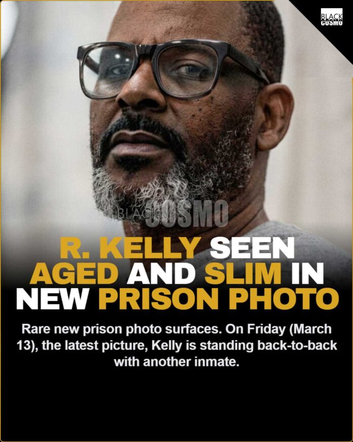 New R. Kelly Prison Photo Surfaces Following Solitary Release (Pics on our site) On Friday (March 13), the latest picture of the disgraced crooner started making its rounds online. In the photo, Kelly is standing back-to-back with another inmate. Kelly has his arms crossed over his chest. The 59-year-old R&B singer is wearing glasses and has a considerable amount of gray in his beard.