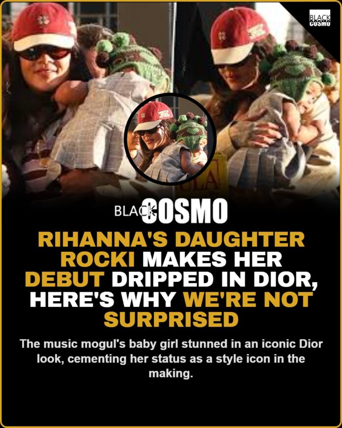 Rihanna’s Daughter Rocki Debuts in Dior Baby Rocki wearing a white Dior outfit with lace details, posing for a photo.
