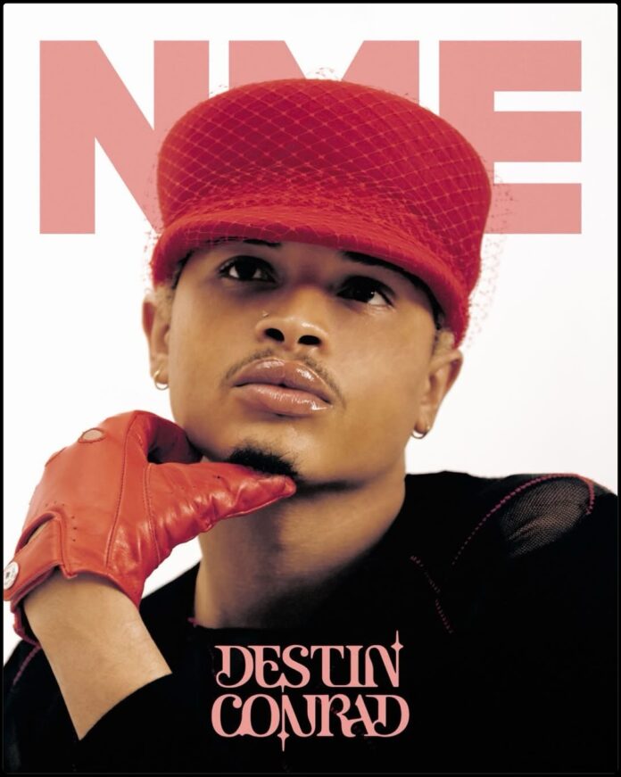 Destin Conrad NME Magazine Cover April 2026 Photos Destin Conrad posing for NME Magazine in a relaxed, high-fashion editorial spread with natural grooming and quiet luxury styling.
