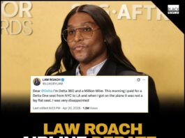 Law Roach posing on a red carpet.