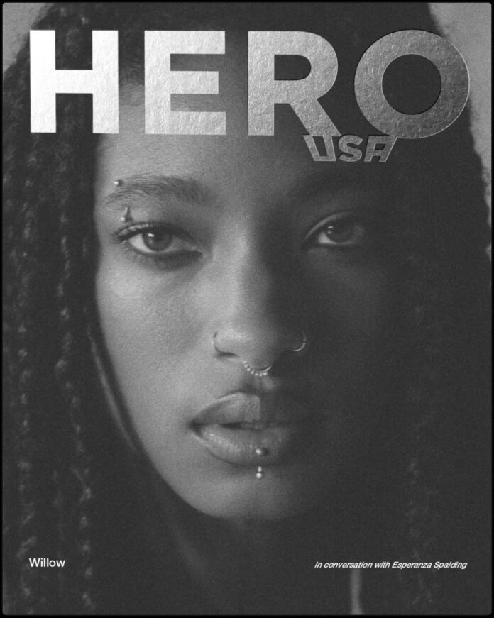 Willow Smith staring into the camera for the April 2026 cover of Hero Magazine USA, featuring complex braided hair styled by Braided Glory.