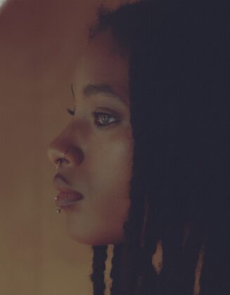 Willow Smith staring into the camera for the April 2026 cover of Hero Magazine USA, featuring complex braided hair styled by Braided Glory.