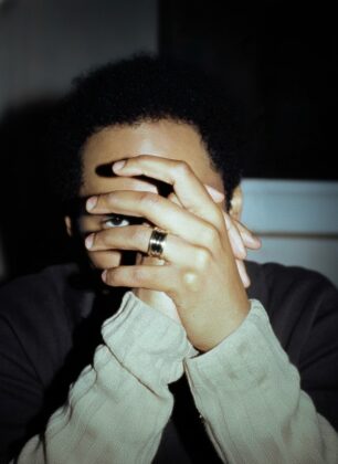 Grammy-winning producer Kaytranada posing for Highsnobiety, wearing avant-garde streetwear styled by Thevonfo, showcasing the intersection of Black culture and high fashion.