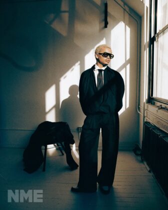 Destin Conrad posing for NME Magazine in a relaxed, high-fashion editorial spread with natural grooming and quiet luxury styling.