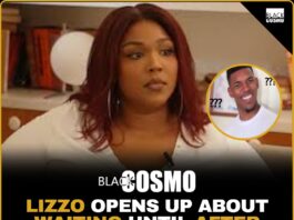 Lizzo posing on the red carpet in a vibrant, colorful outfit