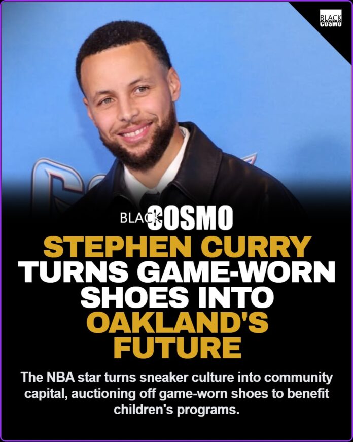 Stephen Curry at a public event wearing a leather jacket.