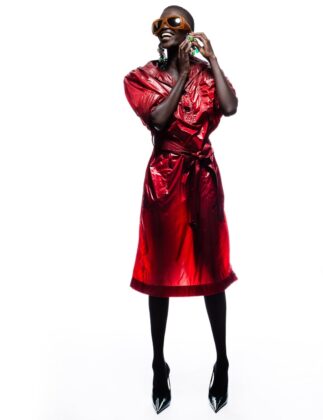 Achok Majak posing in a high-fashion, avant-garde editorial for Flaunt Magazine, featuring bold structural garments and sharp stiletto nails.