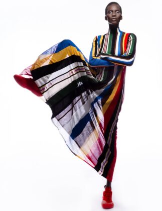 Achok Majak posing in a high-fashion, avant-garde editorial for Flaunt Magazine, featuring bold structural garments and sharp stiletto nails.