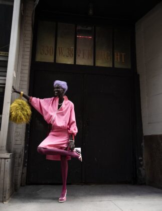 Achok Majak posing in a high-fashion, avant-garde editorial for Flaunt Magazine, featuring bold structural garments and sharp stiletto nails.