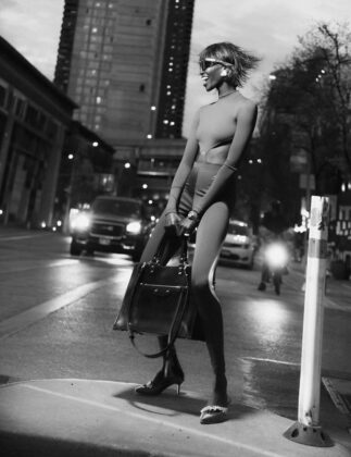 Achok Majak posing in a high-fashion, avant-garde editorial for Flaunt Magazine, featuring bold structural garments and sharp stiletto nails.