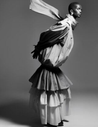 Achok Majak posing in a high-fashion, avant-garde editorial for Flaunt Magazine, featuring bold structural garments and sharp stiletto nails.