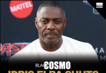 Idris Elba Says Black James Bond Rumors Were Never Realistic Idris Elba wearing a tailored suit, looking sharp and professional.