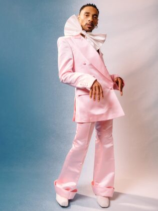 Durand Bernarr posing in a muted lichen green setting with cellular beadwork accessories and textured plumage garments for PAUSE Online June 2026 cover.