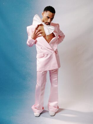 Durand Bernarr posing in a muted lichen green setting with cellular beadwork accessories and textured plumage garments for PAUSE Online June 2026 cover.