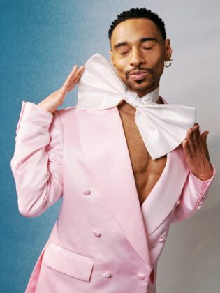 Durand Bernarr posing in a muted lichen green setting with cellular beadwork accessories and textured plumage garments for PAUSE Online June 2026 cover.