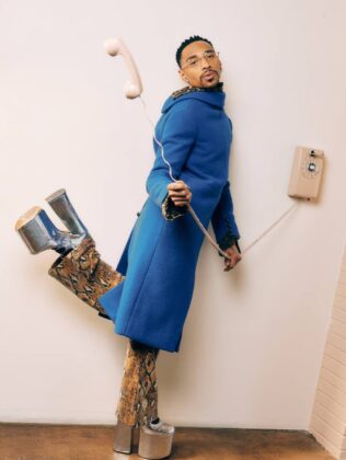Durand Bernarr posing in a muted lichen green setting with cellular beadwork accessories and textured plumage garments for PAUSE Online June 2026 cover.