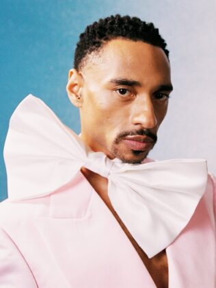 Durand Bernarr posing in a muted lichen green setting with cellular beadwork accessories and textured plumage garments for PAUSE Online June 2026 cover.